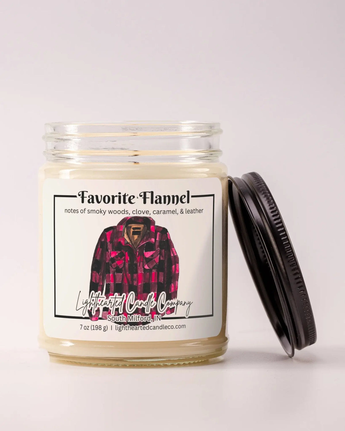 Unlit Favorite Flannel Candle in a clear glass jar with its black lid beside it, alternate view 10