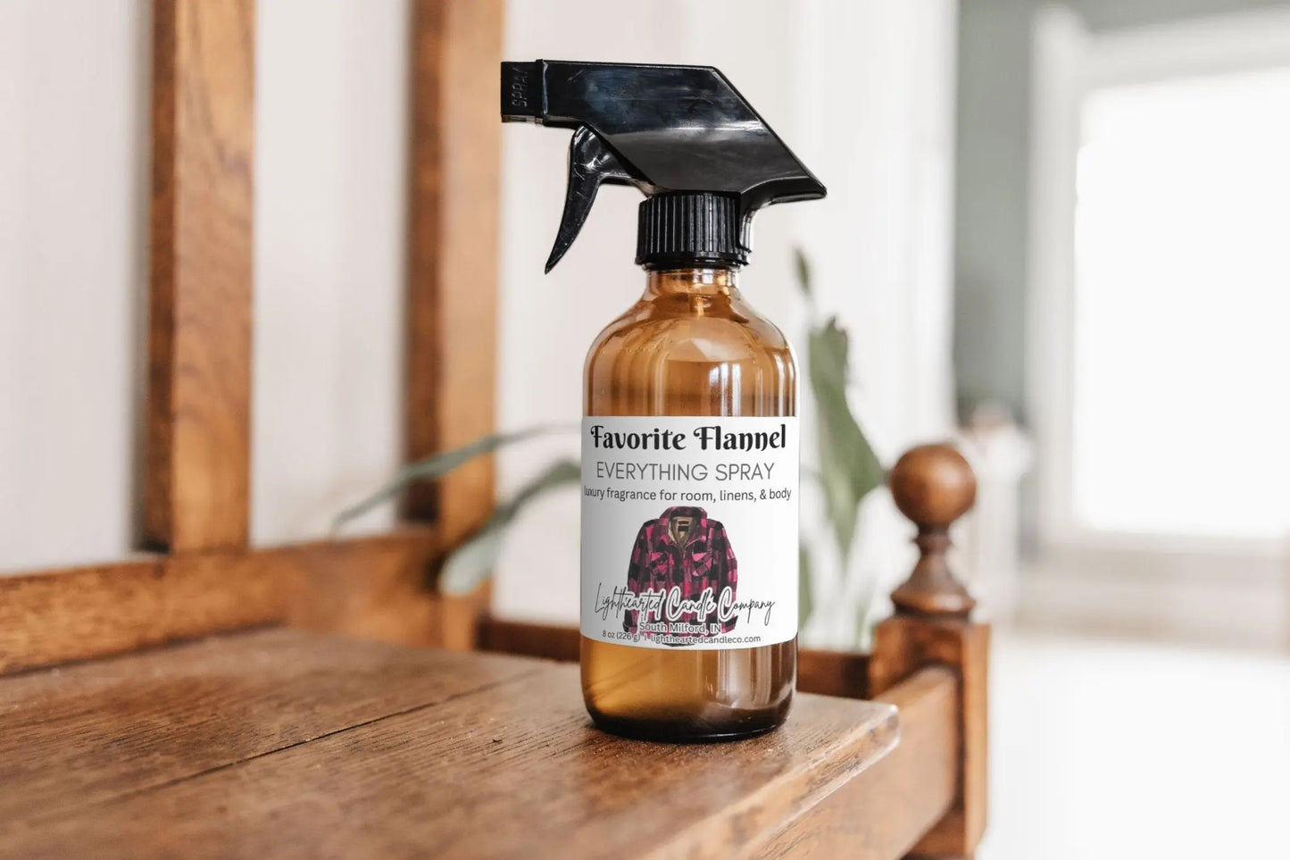 Favorite Flannel Everything Spray on a wooden dresser in a bright bedroom