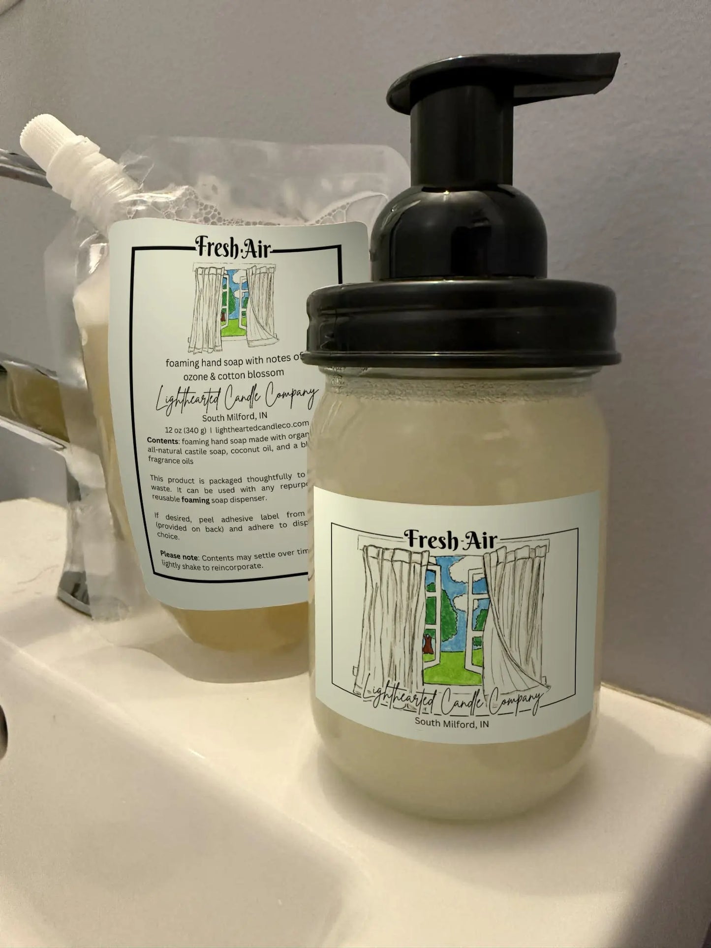 Fresh Air foaming soap refill pouch and filled glass foaming dispenser shown together