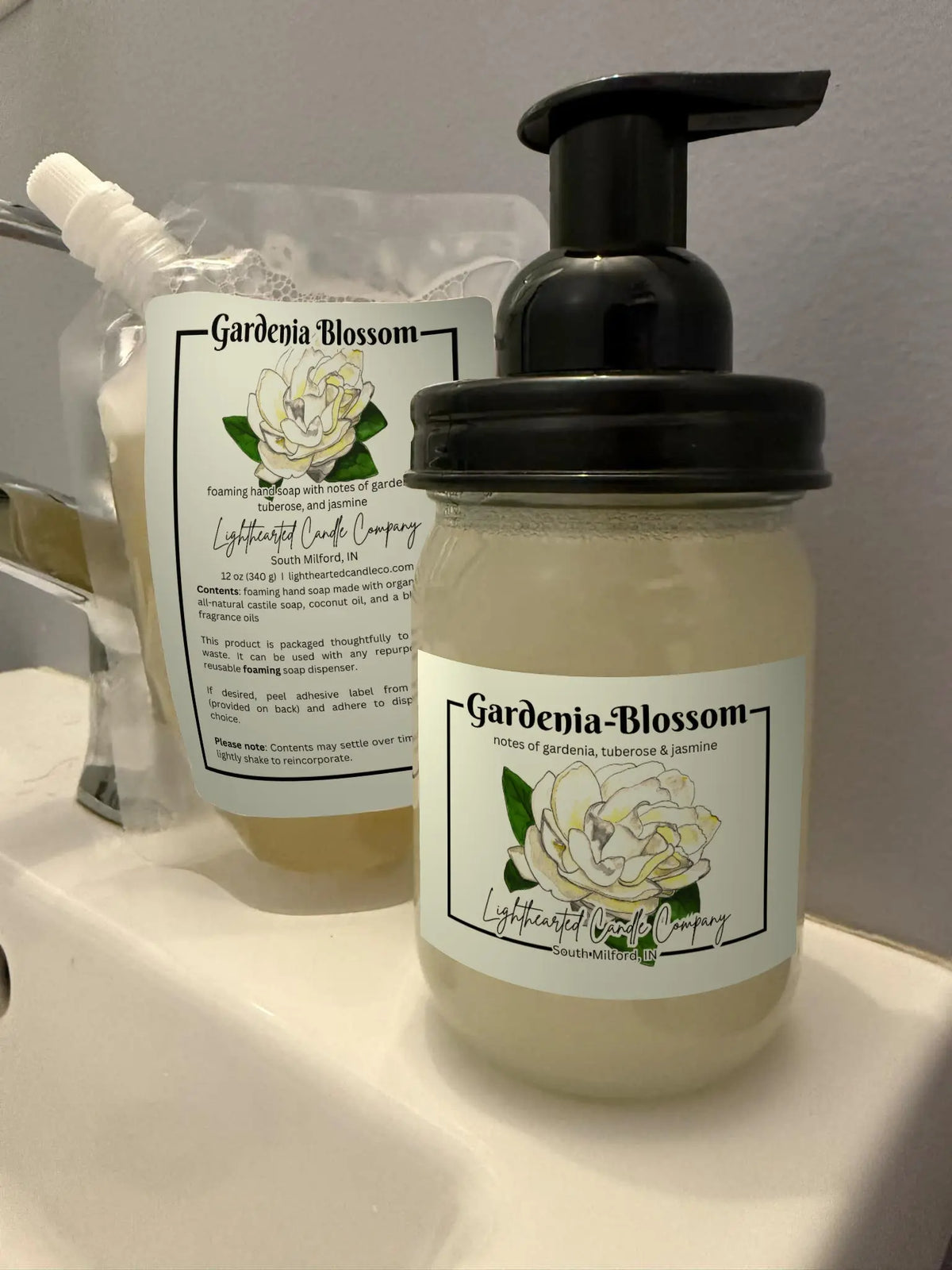 Gardenia Blossom foaming soap refill pouch and filled glass foaming dispenser shown together
