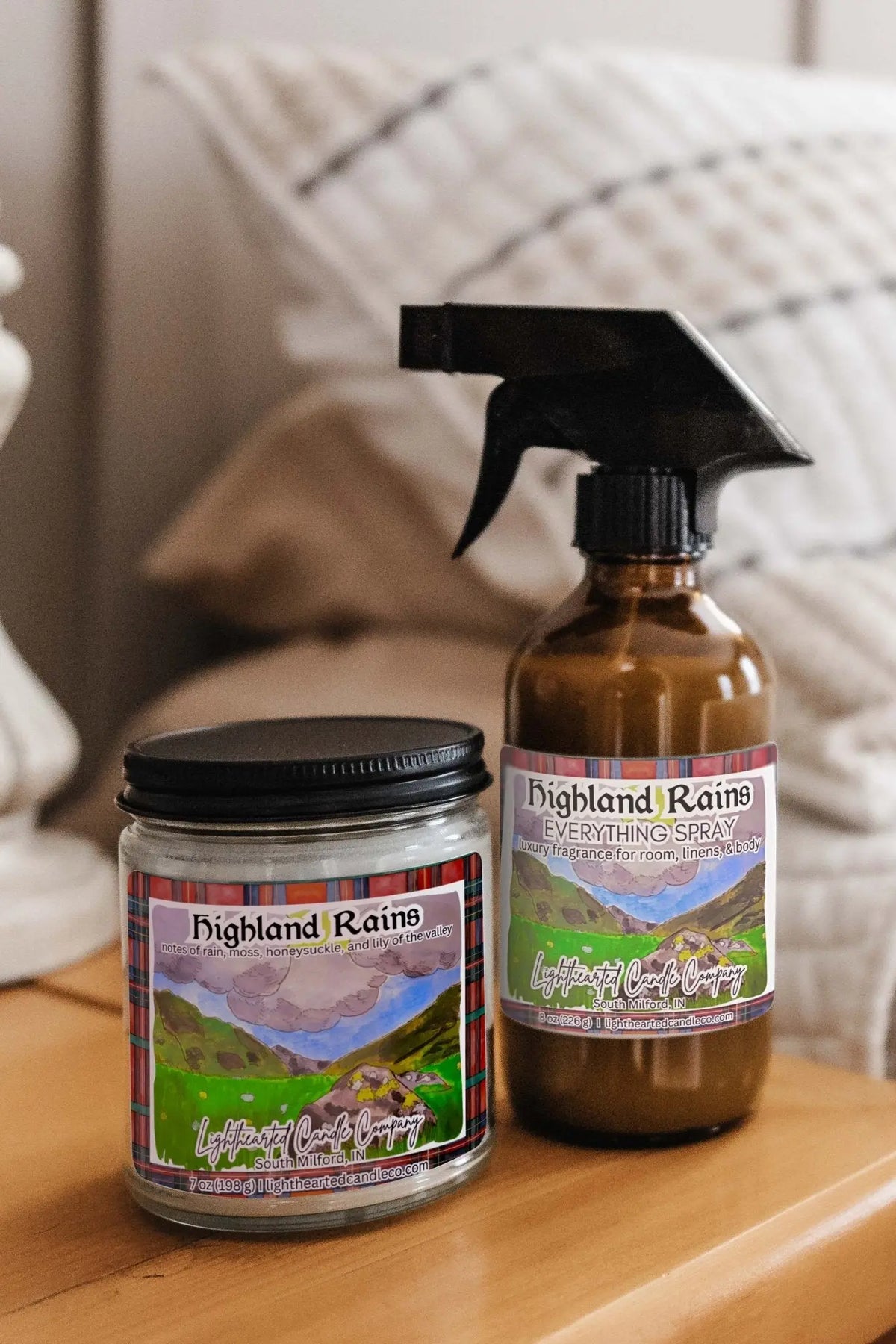 Matching candle and Highland Rains Spray styled on a bedside table