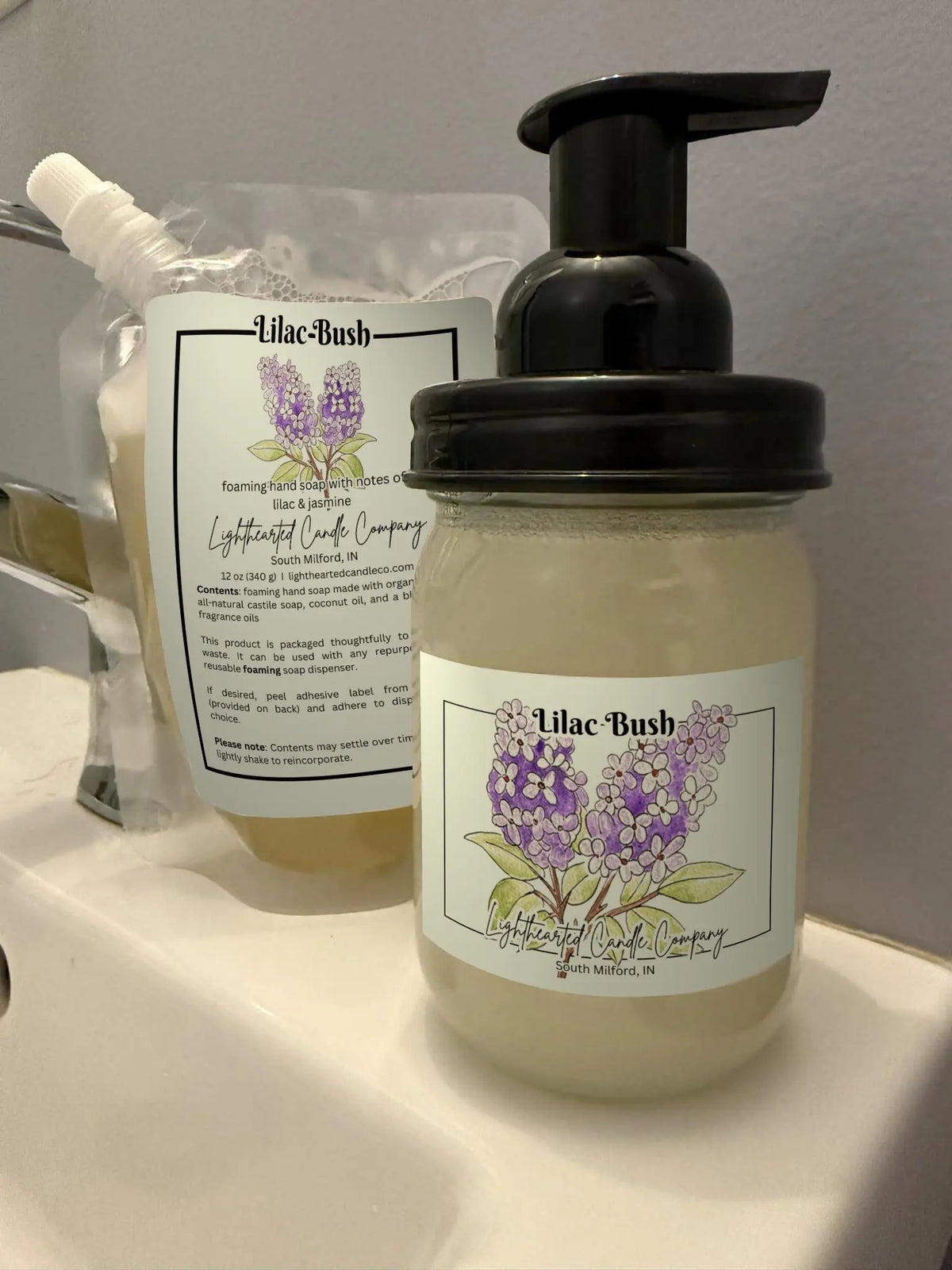 Lilac Bush foaming soap refill pouch and filled glass foaming dispenser shown together
