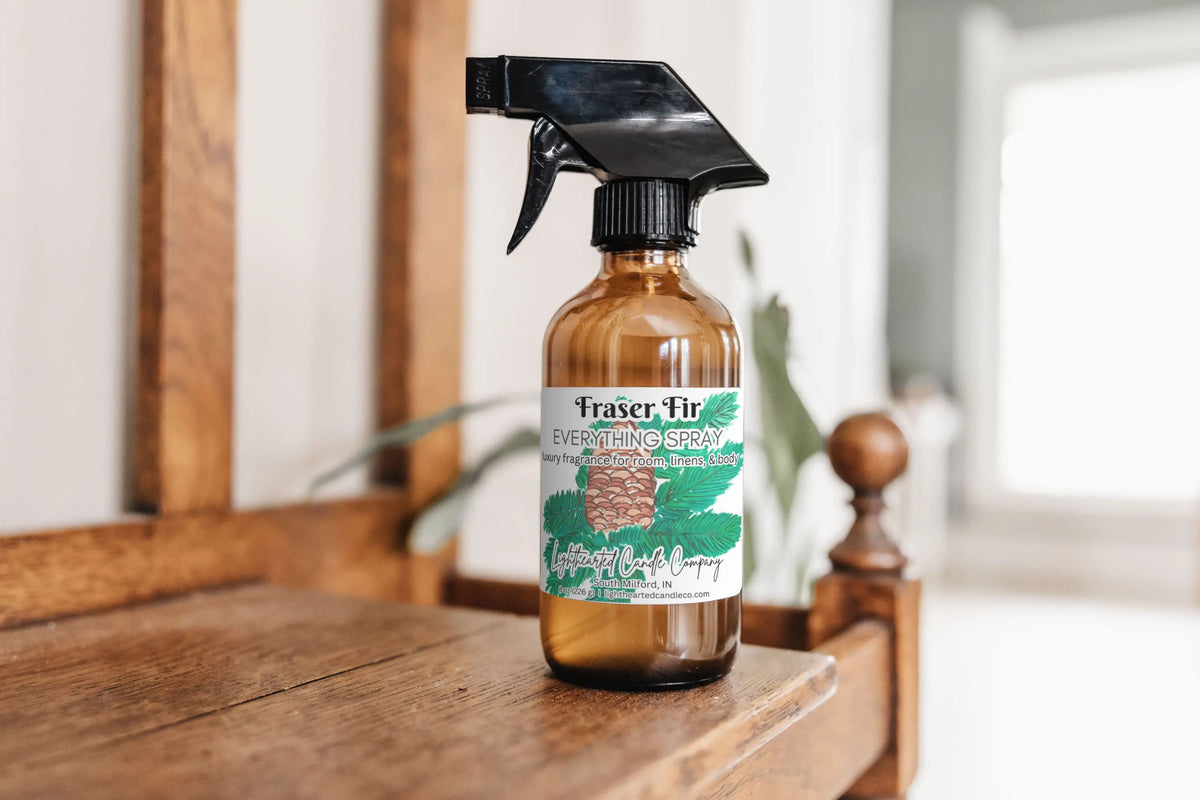 Fraser Fir Everything Spray on a wooden dresser in a bright bedroom
