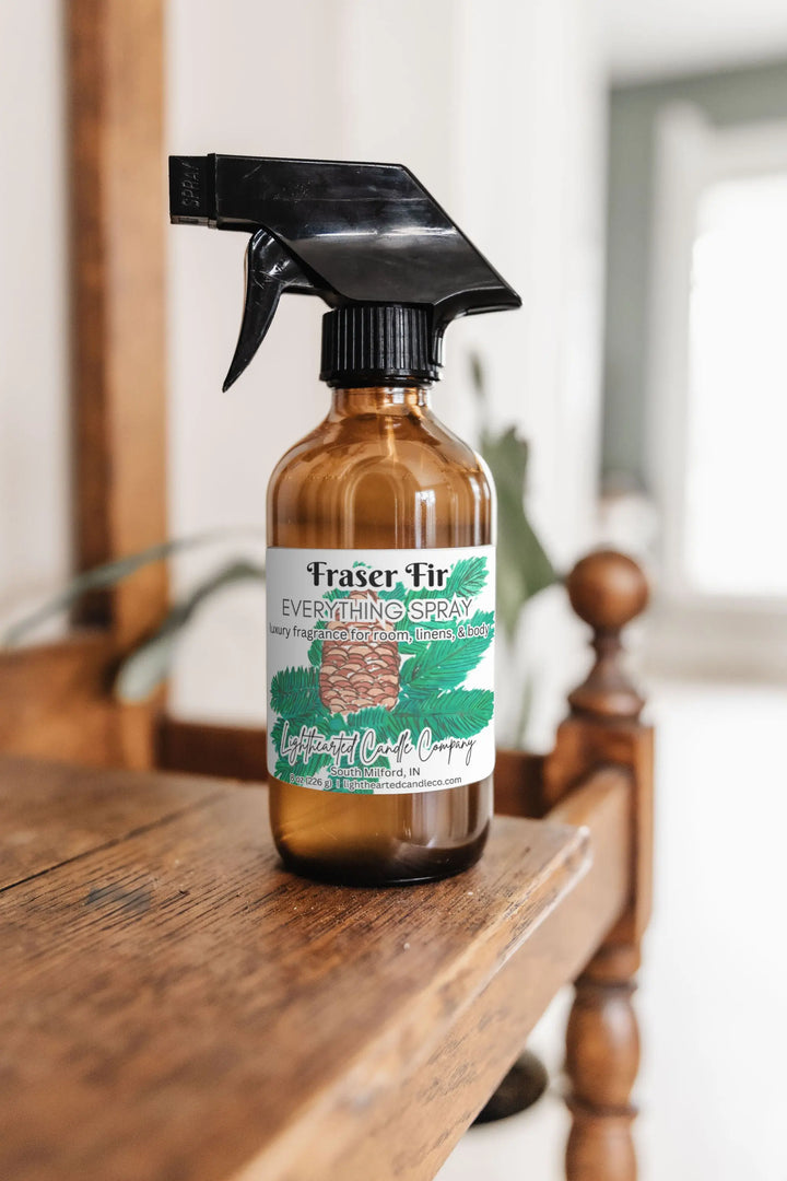 Fraser Fir Everything Spray in an amber glass bottle on a wooden dresser