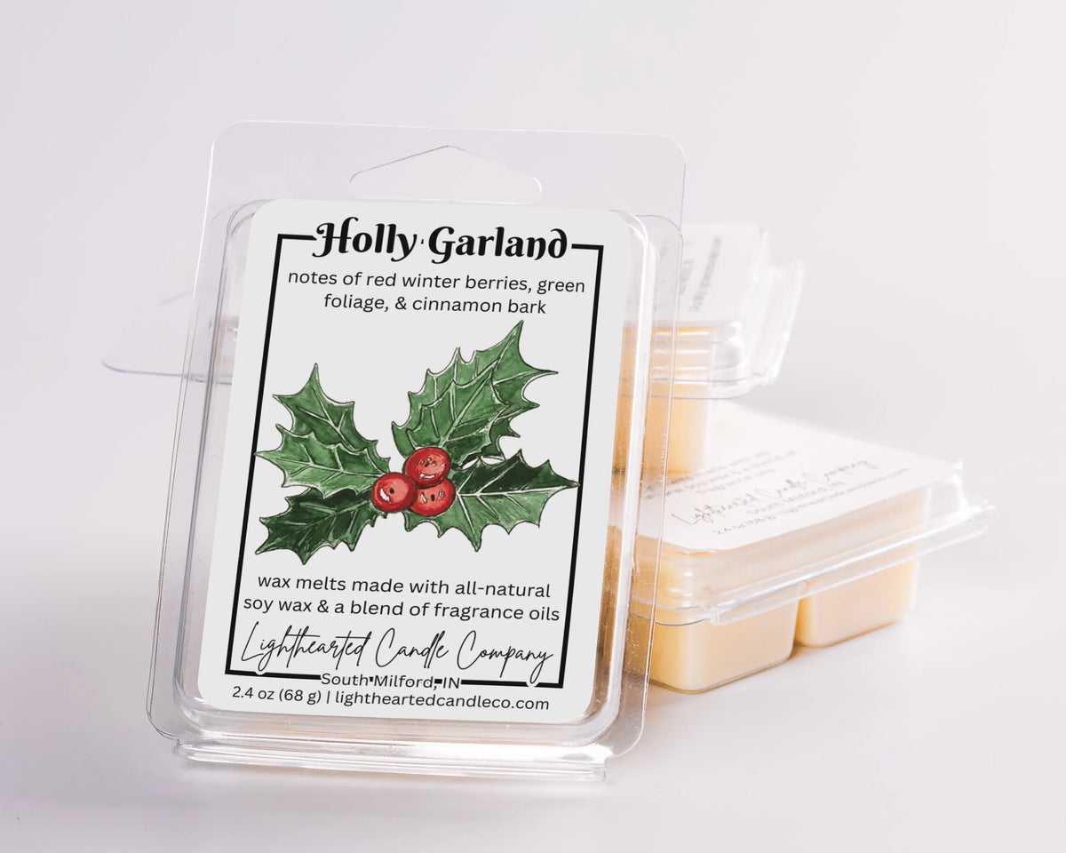 Holly Garland Wax Melt clamshells arranged in a stack on a pale background