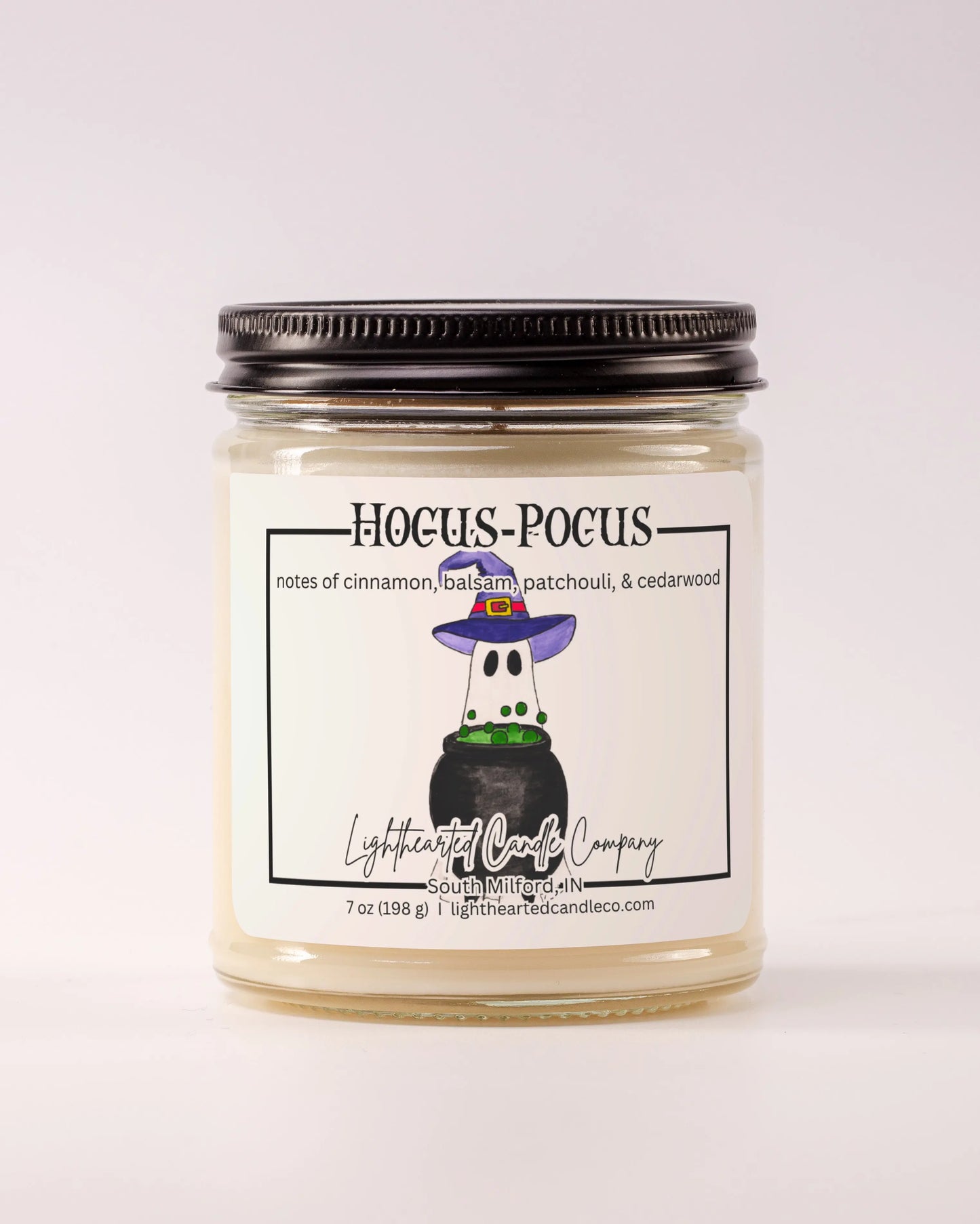 Closed Hocus Pocus Candle in a clear glass jar with a black metal lid