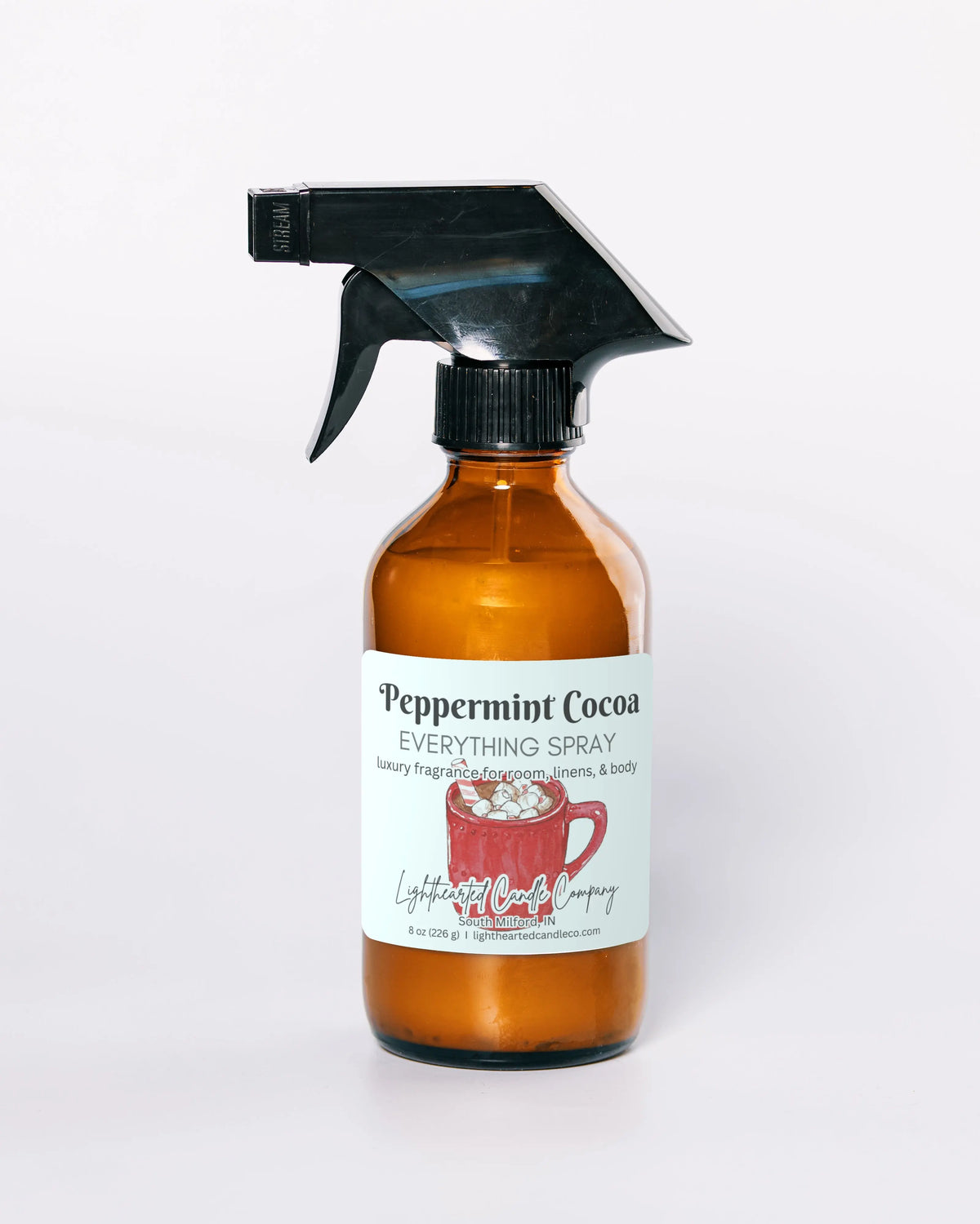 Peppermint Cocoa Everything Spray in an amber glass bottle on a pale background