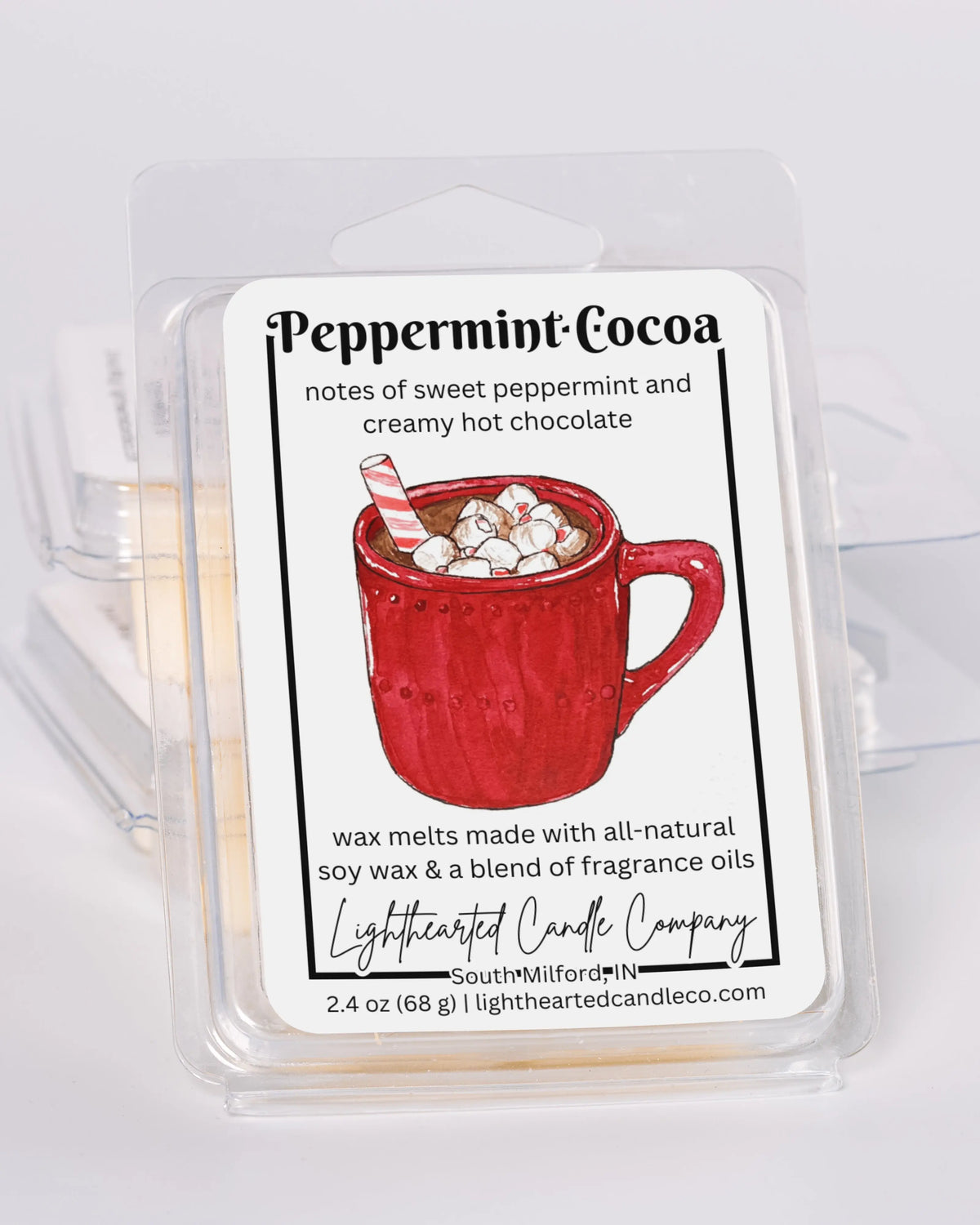 Peppermint Cocoa Wax Melt clamshells stacked at an angle on a pale background