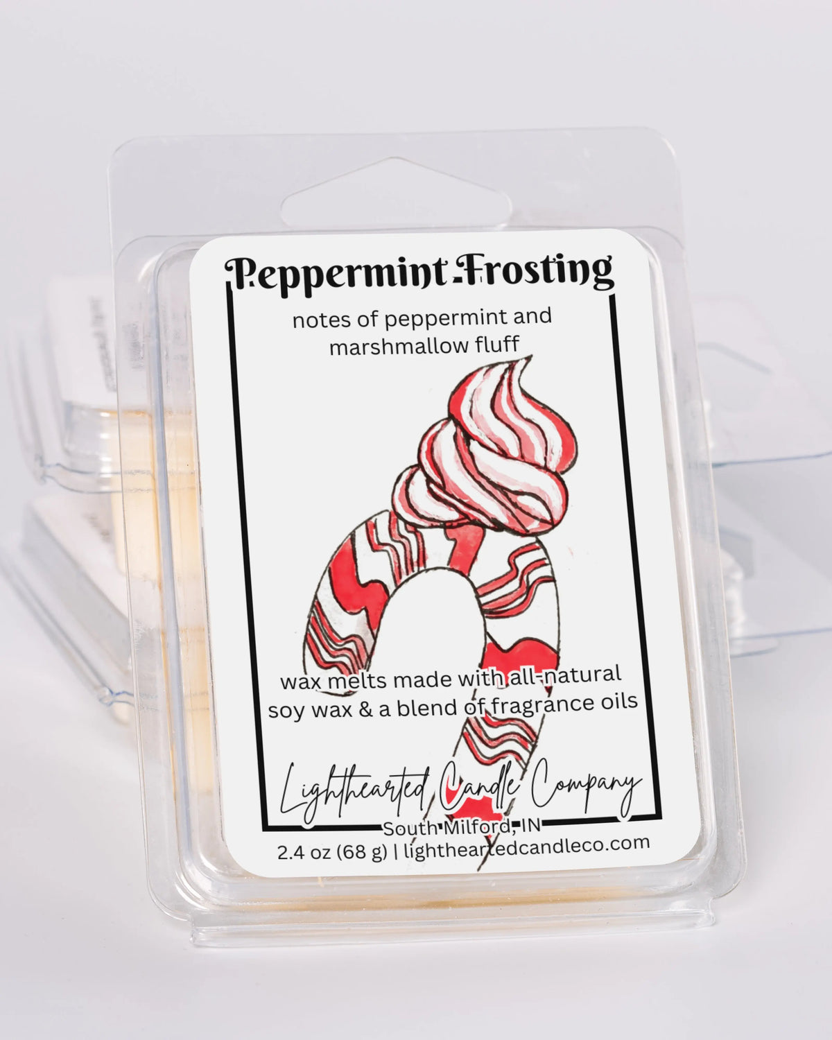 Peppermint Frosting Wax Melt clamshells stacked at an angle on a pale background