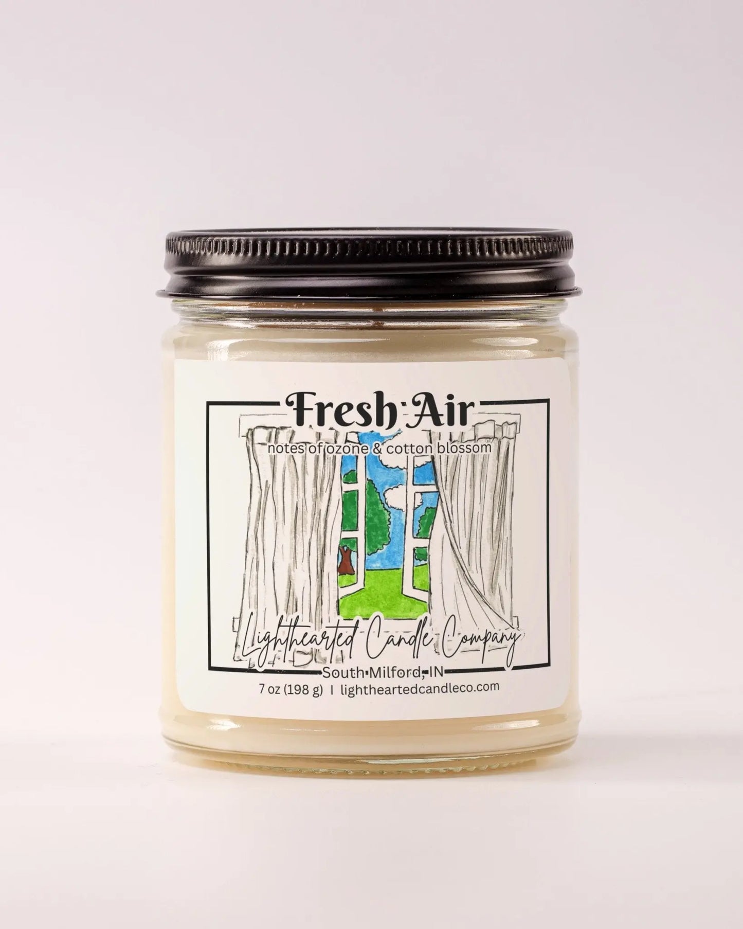Closed Fresh Air Candle in a clear glass jar with a black metal lid