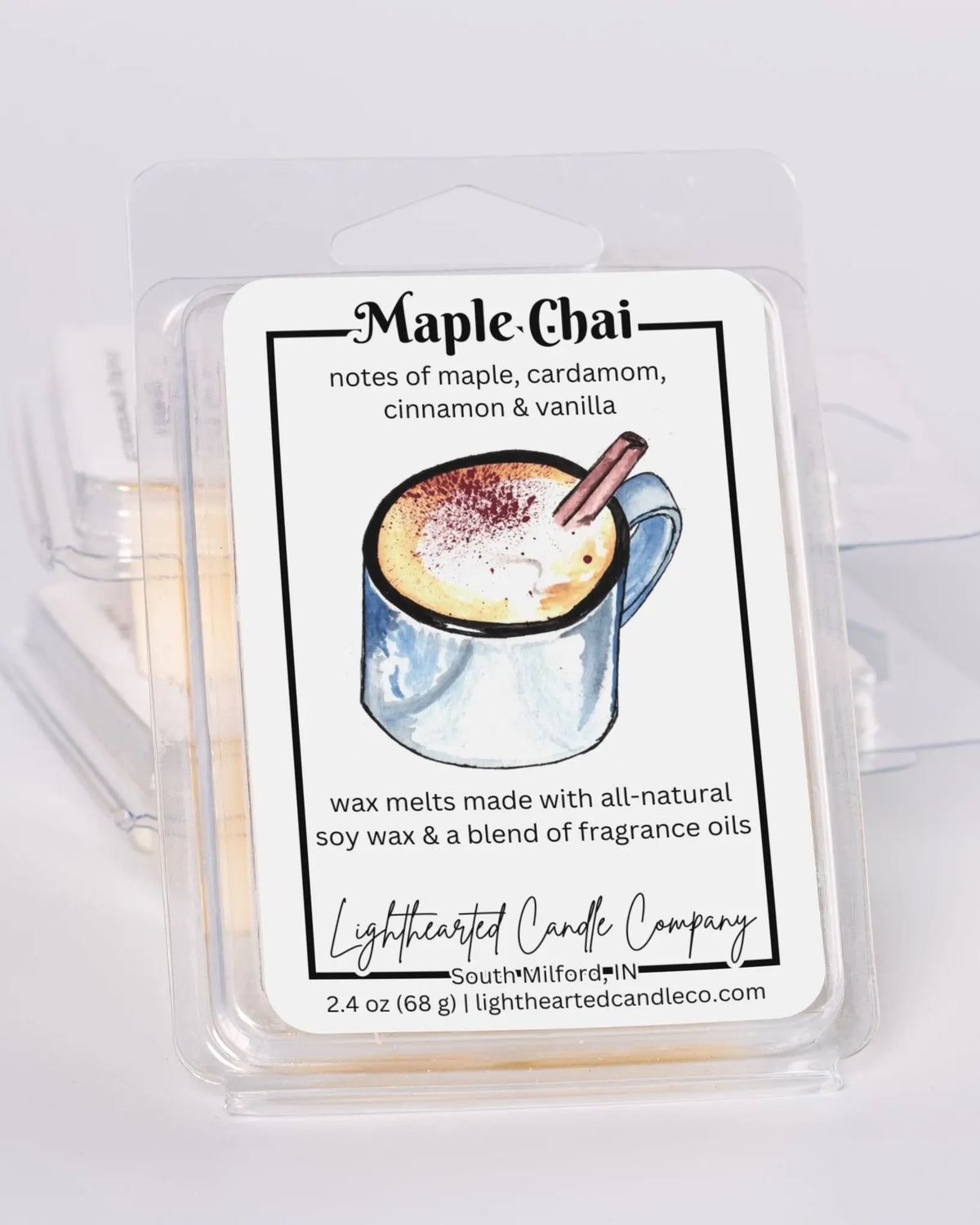 Maple Chai Wax Melt clamshells stacked at an angle on a pale background