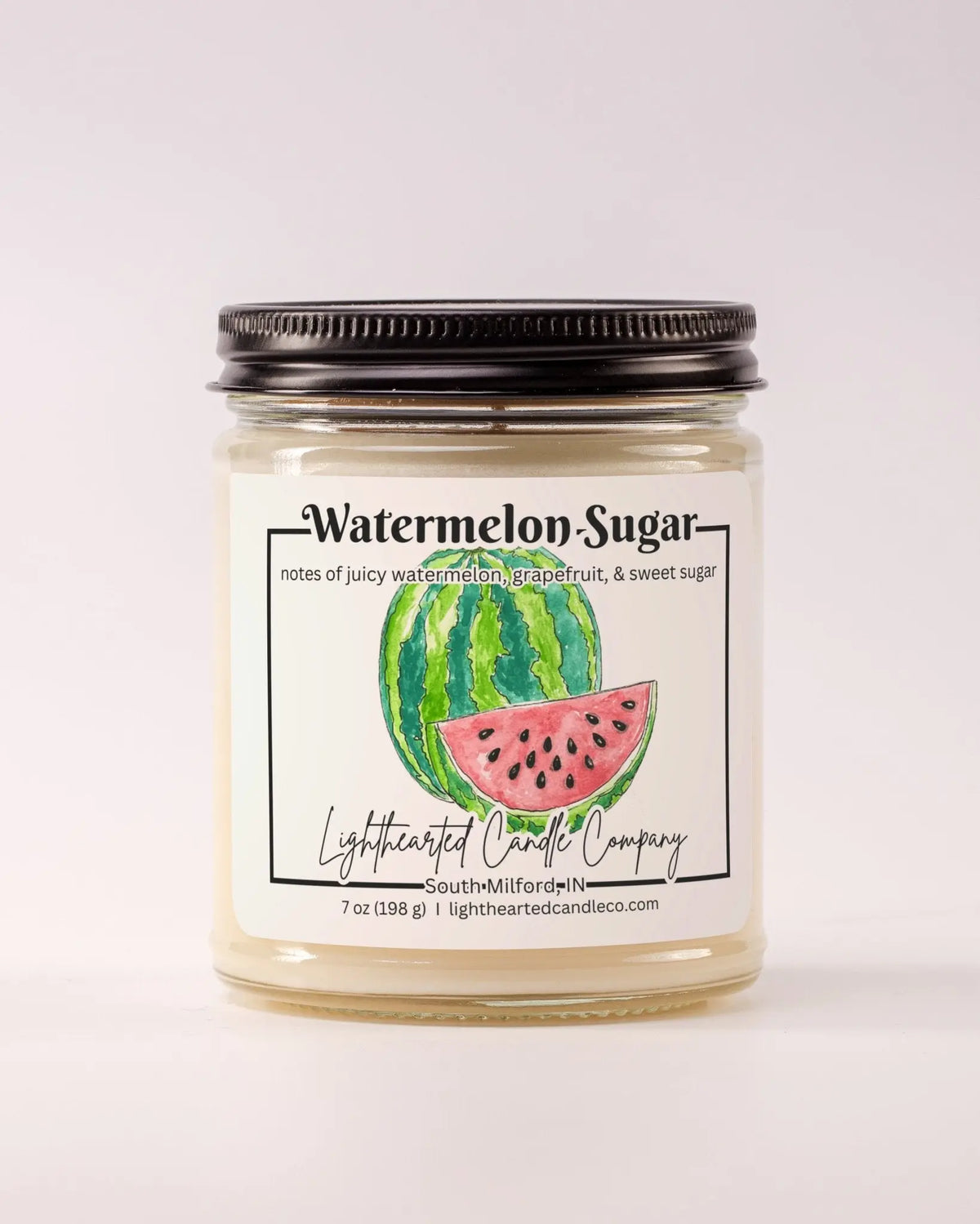 Closed Watermelon Sugar Candle in a clear glass jar with a black metal lid